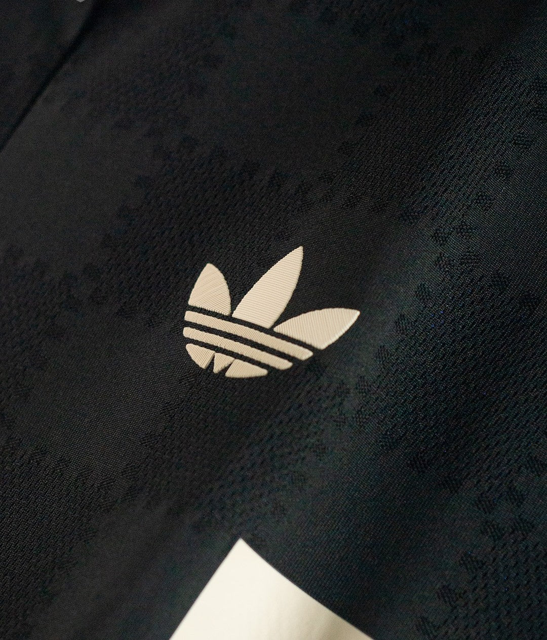 Hoop Store Bayern Munich third jersey 2025-26 close up of black fabric with white Adidas trefoil logo