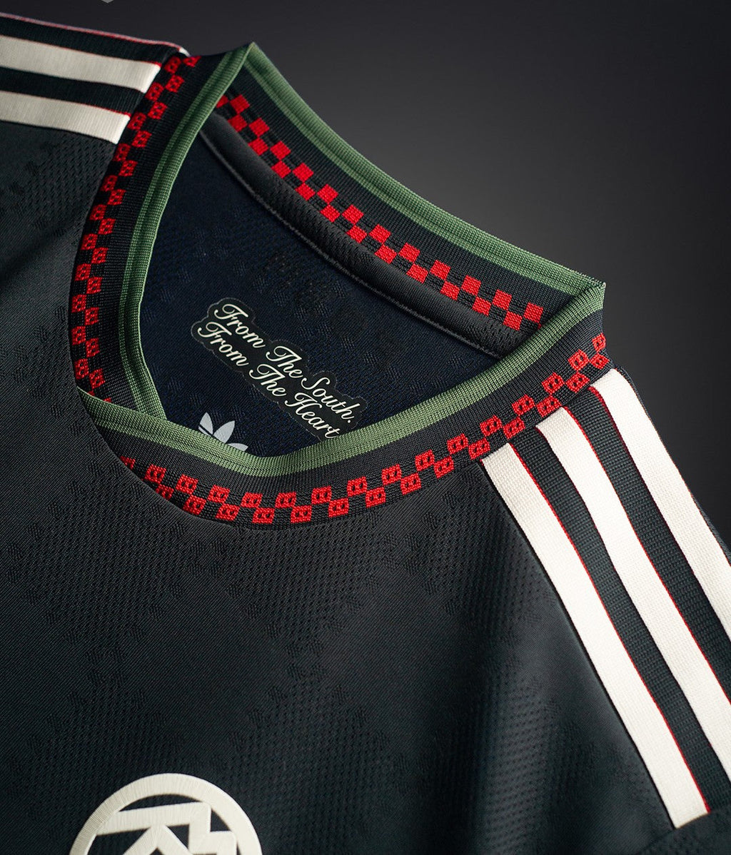 Hoop Store Bayern Munich third jersey 2025-26 black close up showing green collar red checker trim and white shoulder stripes