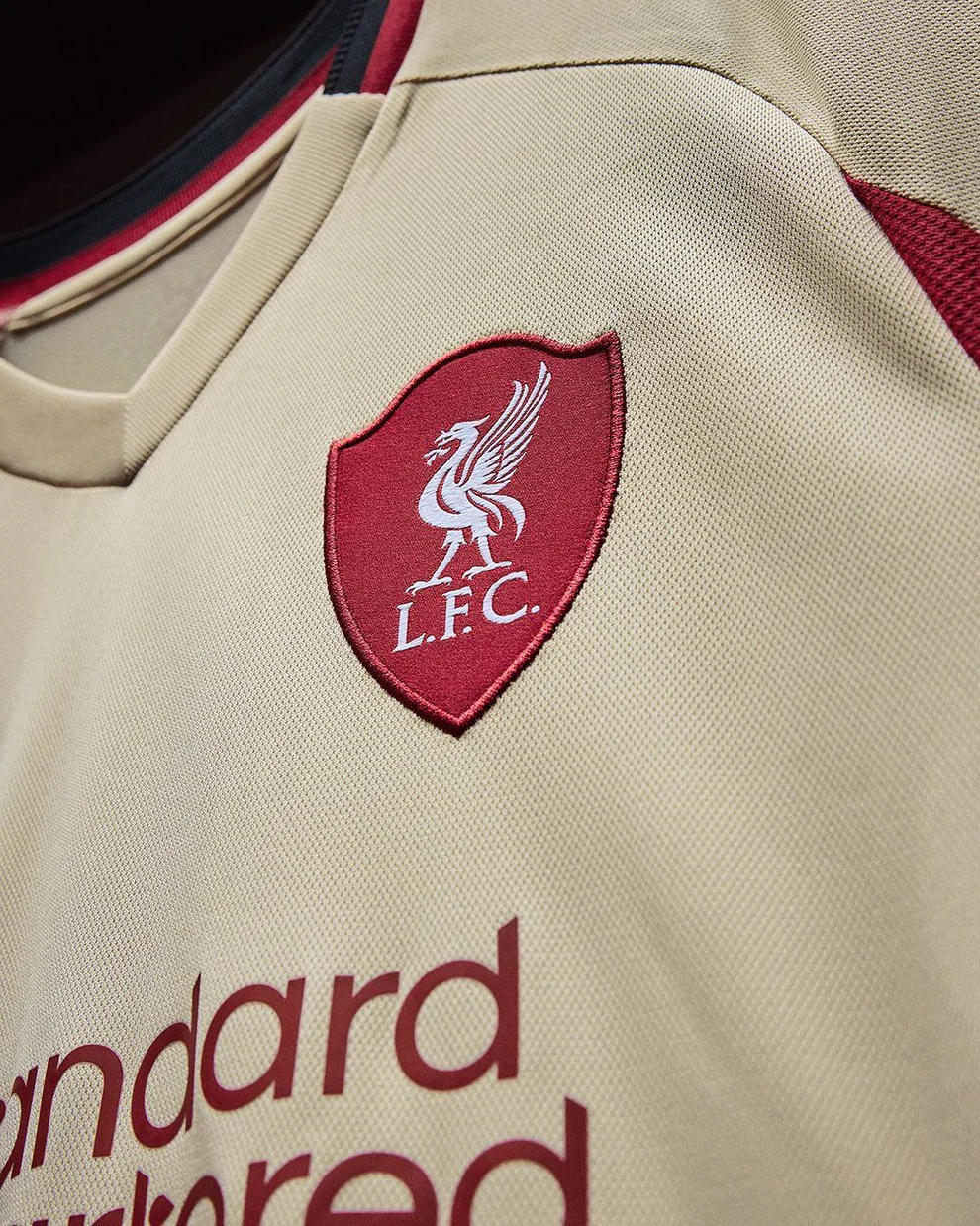Hoop Store Liverpool Away Jersey 2025-26 beige jersey with embroidered LFC crest and sponsor logo