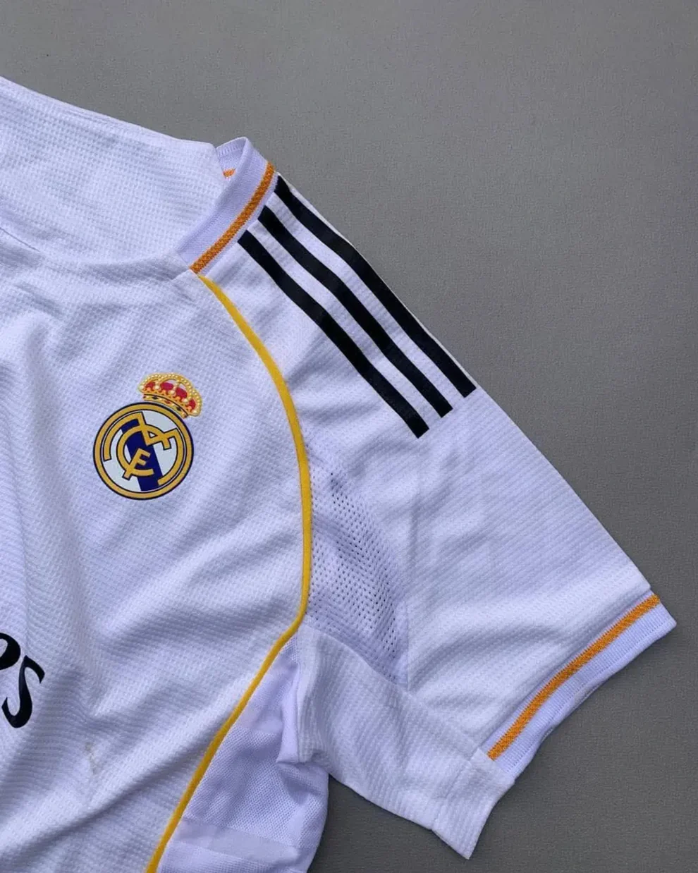 Hoop Store Real Madrid 2025 home jersey white mesh with club crest black shoulder stripes and gold trim