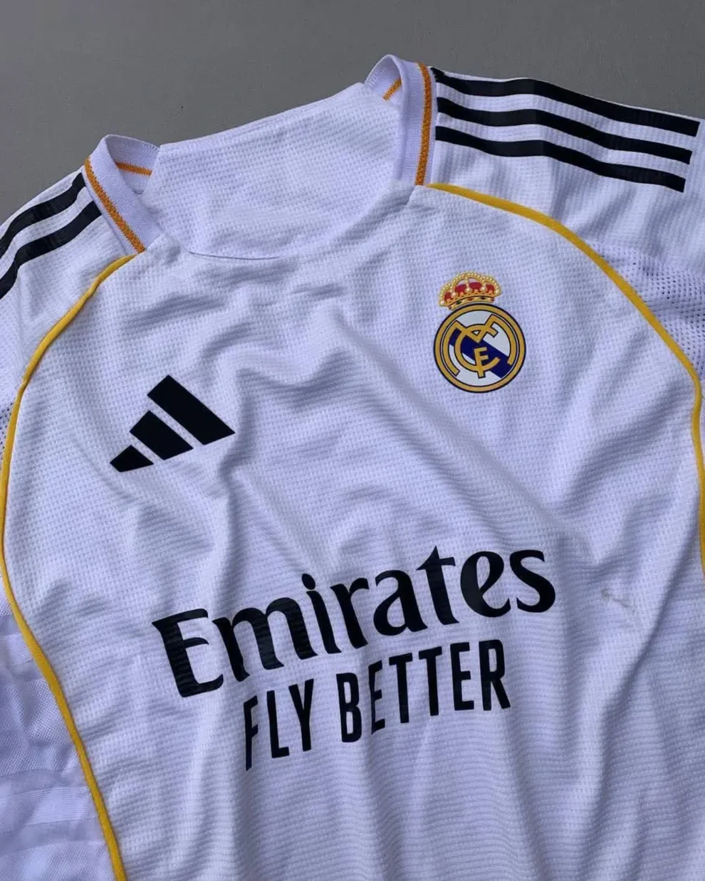 Real Madrid 2025 home jersey Hoop Store white club kit with gold trim Adidas logo and Emirates sponsor