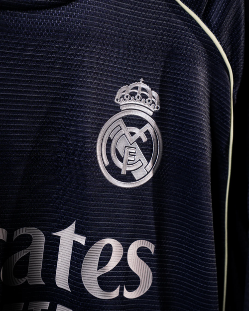 Close-up of Real Madrid away jersey 2025 26 showing club crest and fabric texture