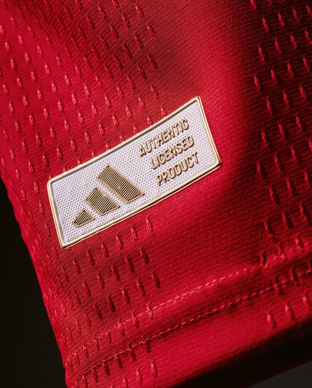 Close-up of authentic Adidas tag on the Arsenal Home Jersey 2026-27 in red fabric