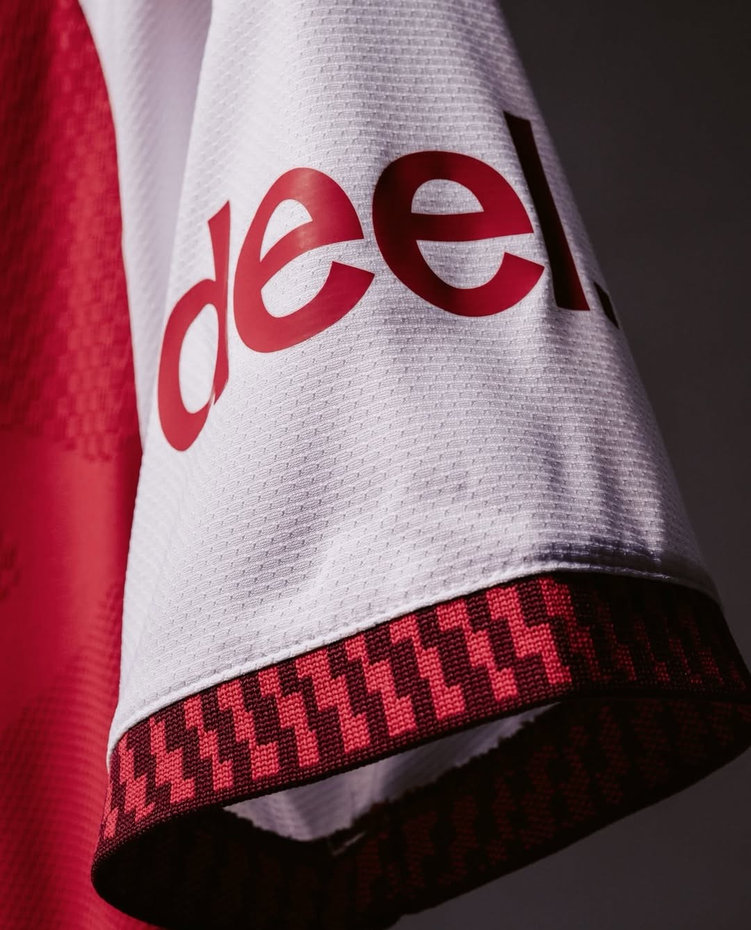 Close-up of Arsenal Home Jersey 2026-27 sleeve detailing showcasing the brand logo and fabric texture