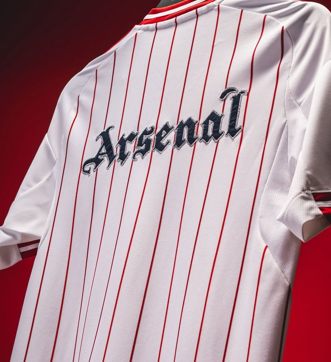 Arsenal US Pack shirt 2025-26 special edition featuring a red and white striped design