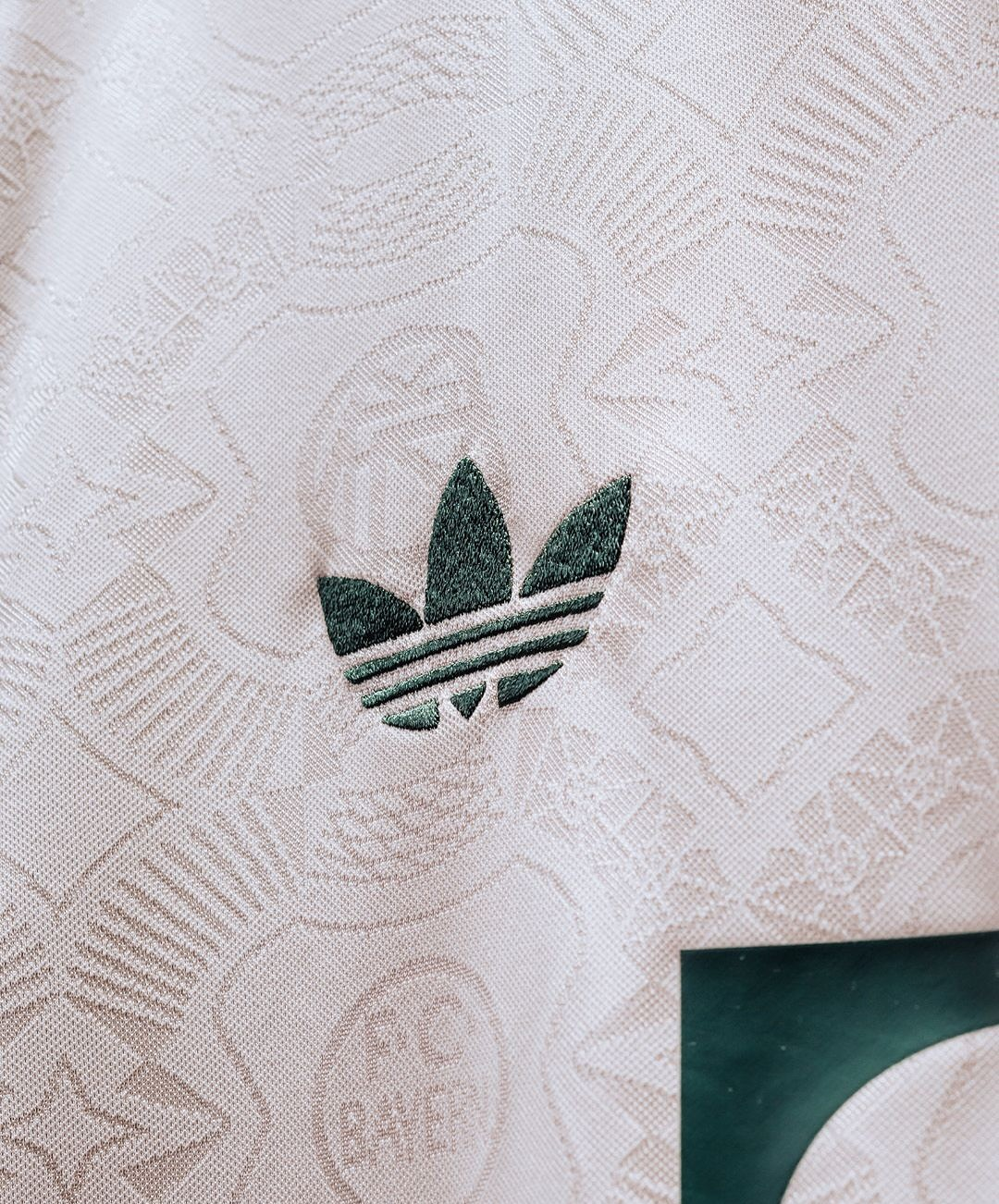 Detailed view of the Adidas logo on the Bayern Munich Oktoberfest jersey 2025-26 featuring a unique design