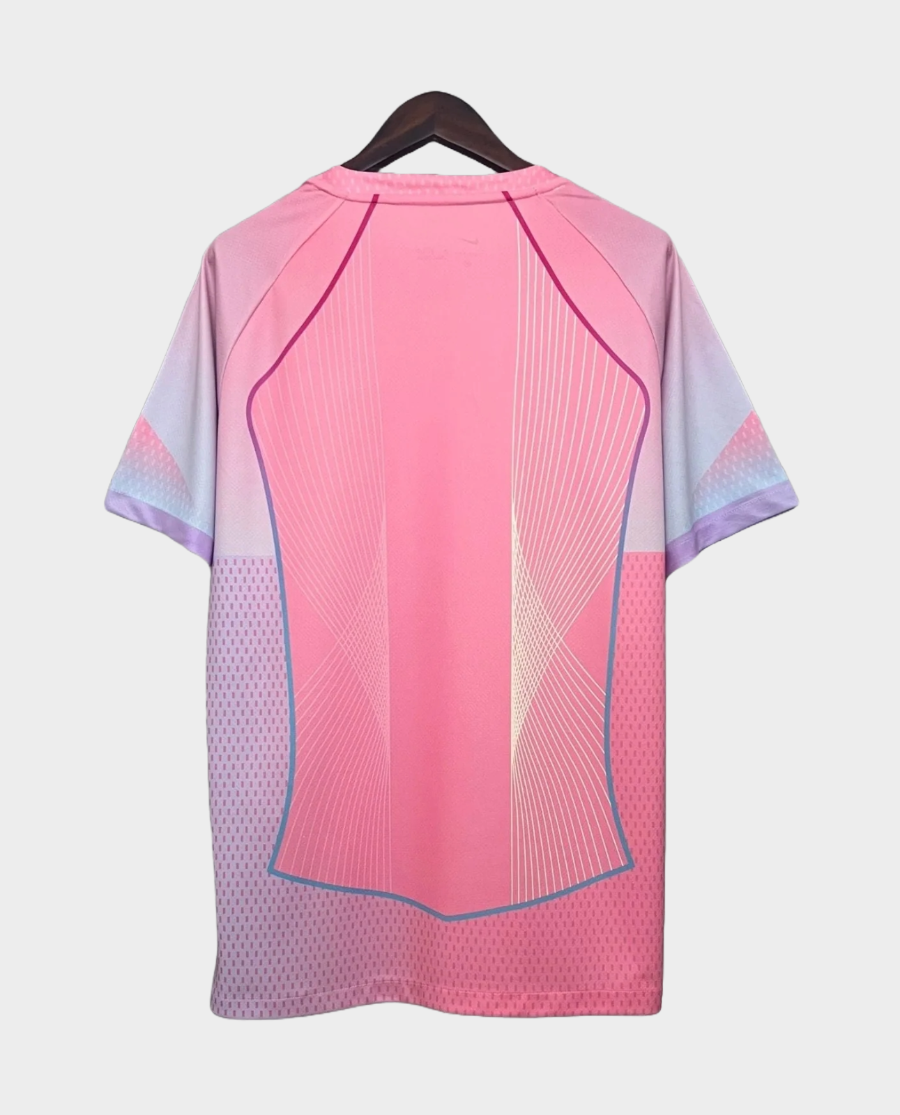 Back view of FC Barcelona Pink Jersey 2025 with gradient pink design hanging on black hanger