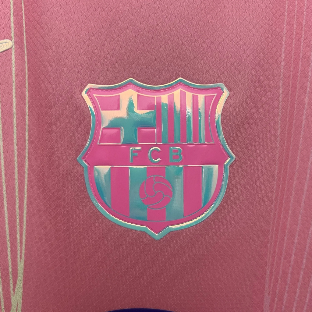 Close-up of FC Barcelona Pink Jersey 2025 with detailed club crest on pink fabric