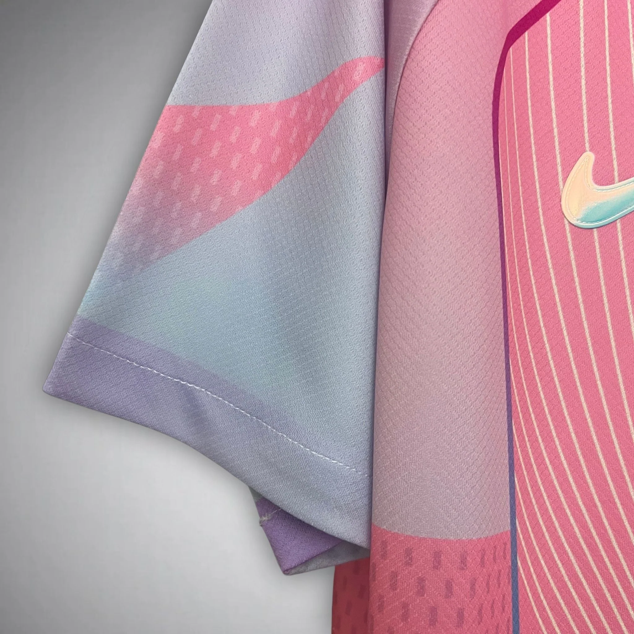 Close-up of FC Barcelona Pink Jersey 2025 sleeve showing light purple and pink fabric with Nike logo