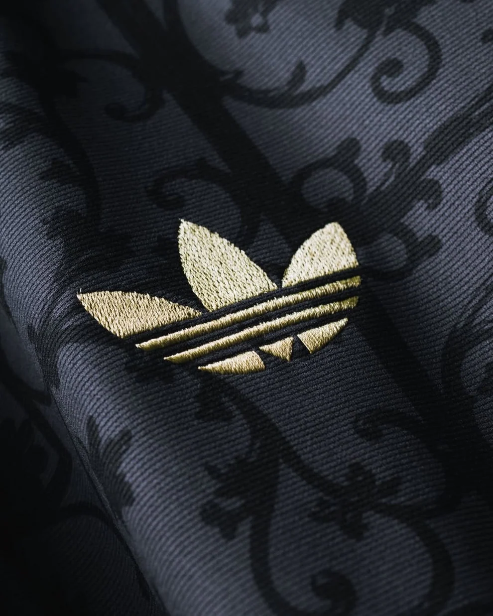 Close-up of the intricate pattern on Liverpool LFSTLR Special Edition Jersey with gold Adidas logo