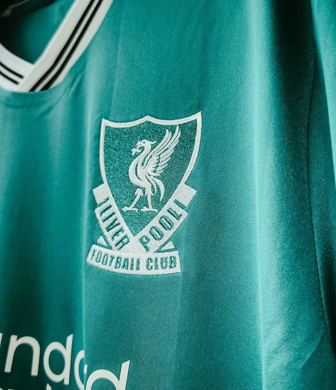 Close-up of Liverpool third jersey 2025-26 player version with club logo and vibrant colors