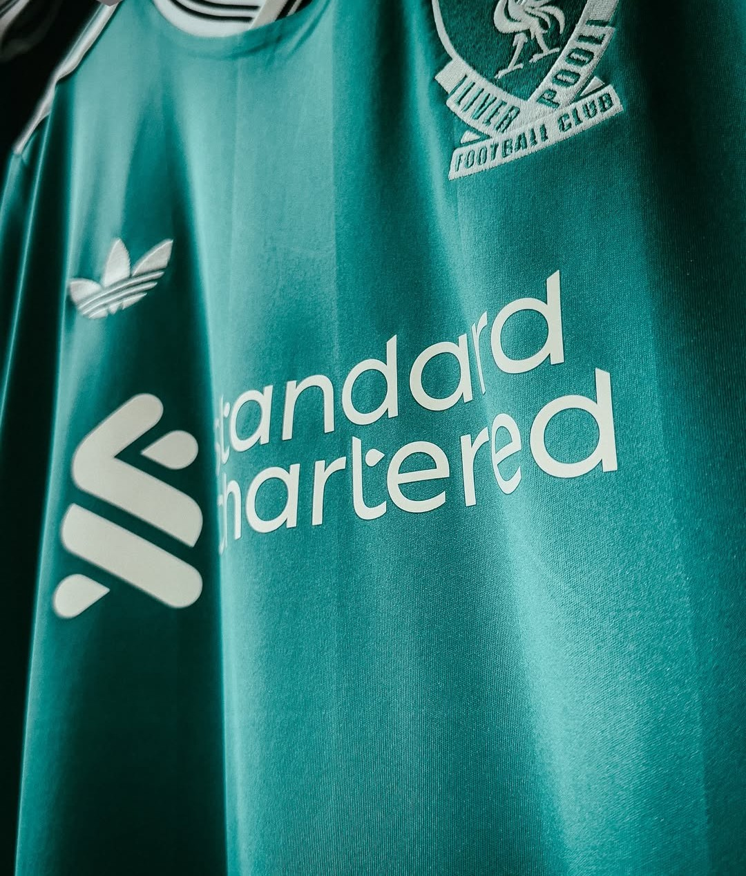 Liverpool third jersey 2025-26 player version in teal with Standard Chartered logo and Adidas branding