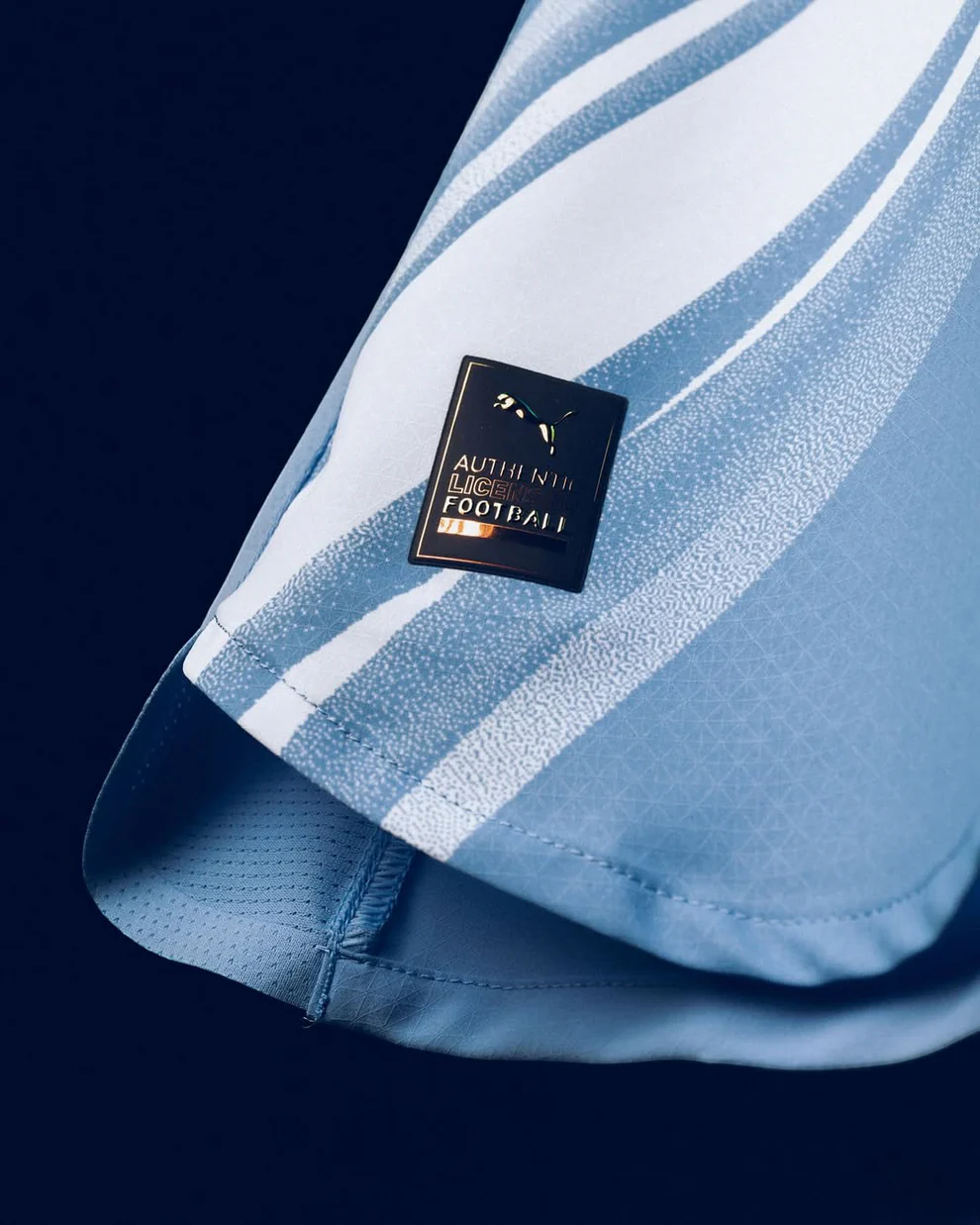 Close-up of the Manchester City 2025-26 Home Jersey featuring a special authenticity badge from Hoop Store