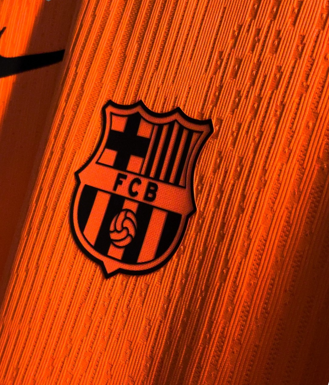 Hoop Store close up of orange Barcelona third jersey 2025-26 player version showing embossed club crest and textured fabric