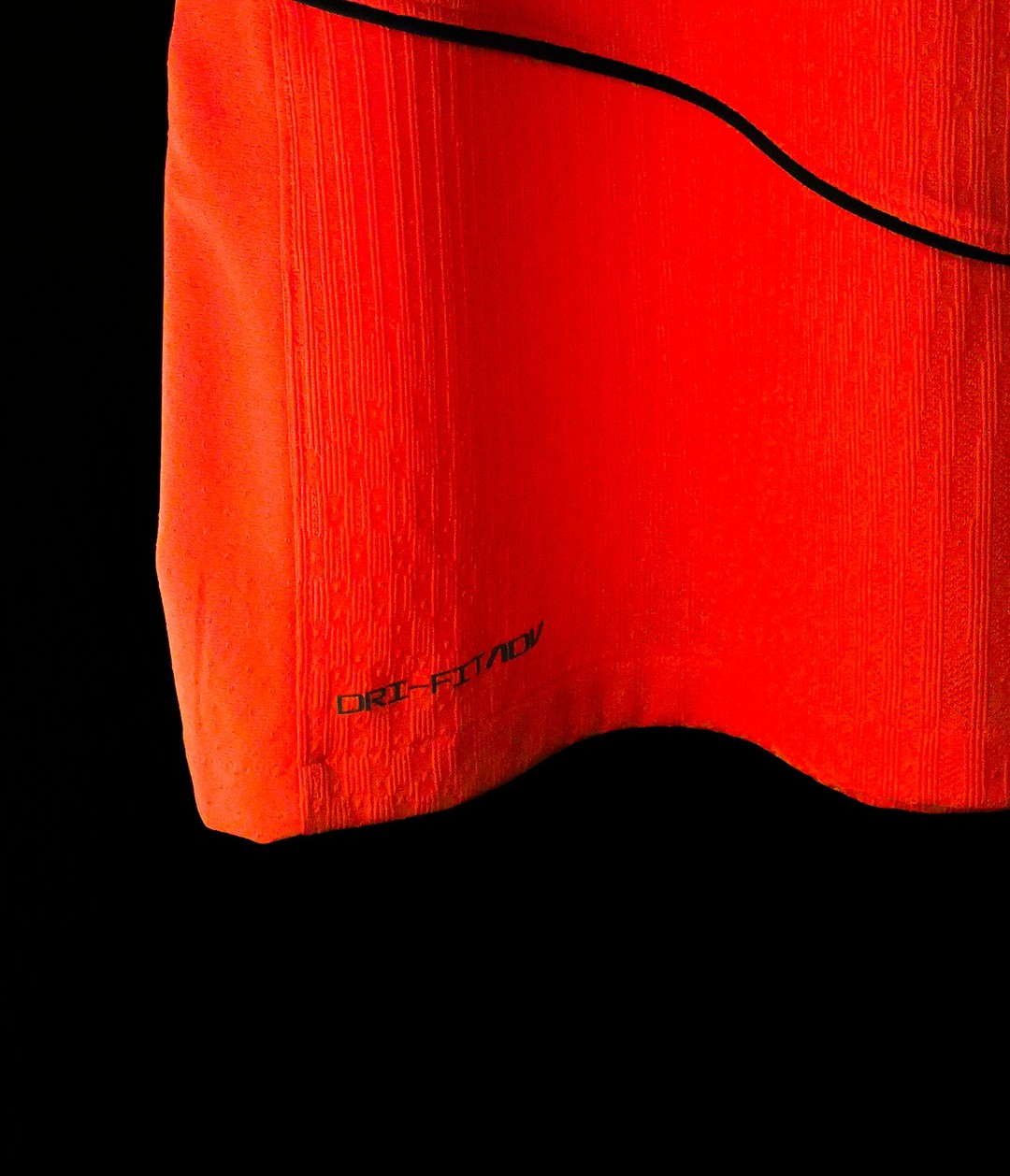 Hoop Store close up of Barcelona third jersey 2025-26 player version orange red hem with black piping and DriFit texture
