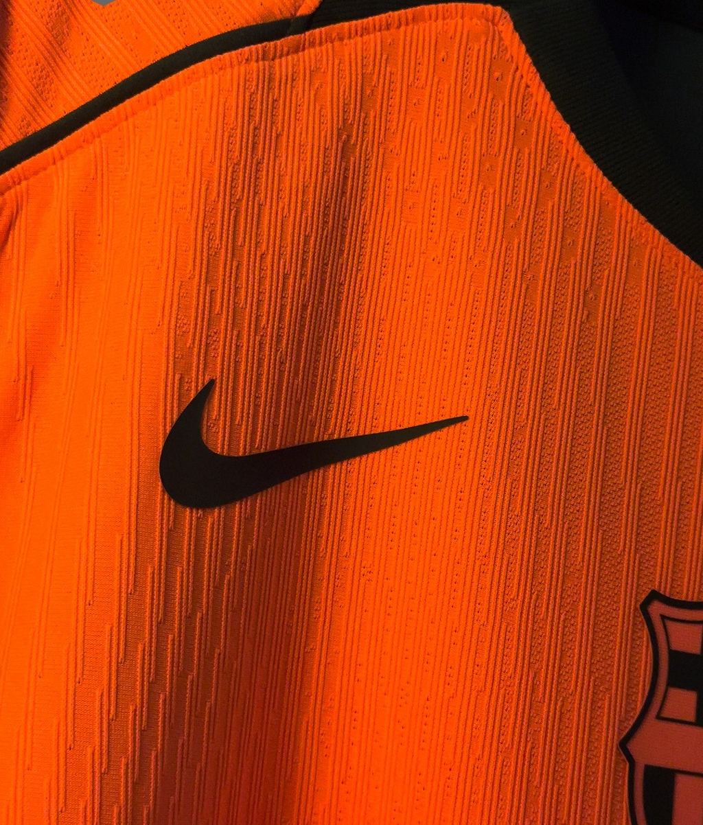 Hoop Store Barcelona third jersey 2025-26 player version orange close up showing Nike swoosh and club crest