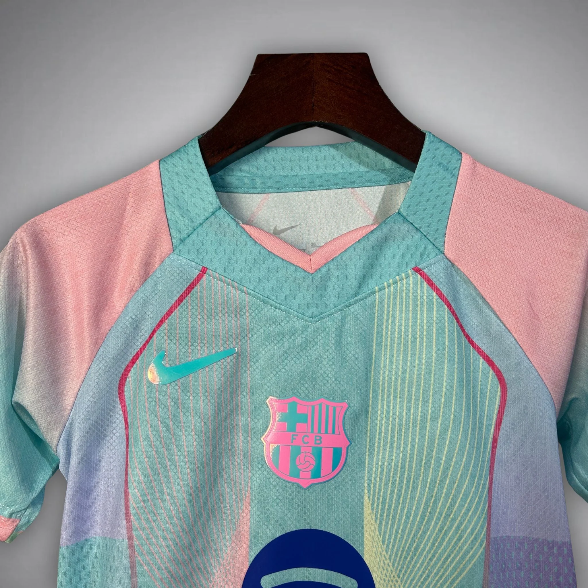Hoop Store FC Barcelona Blue Edition Jersey 2025-26 pastel aqua and pink Nike crest front view on hanger