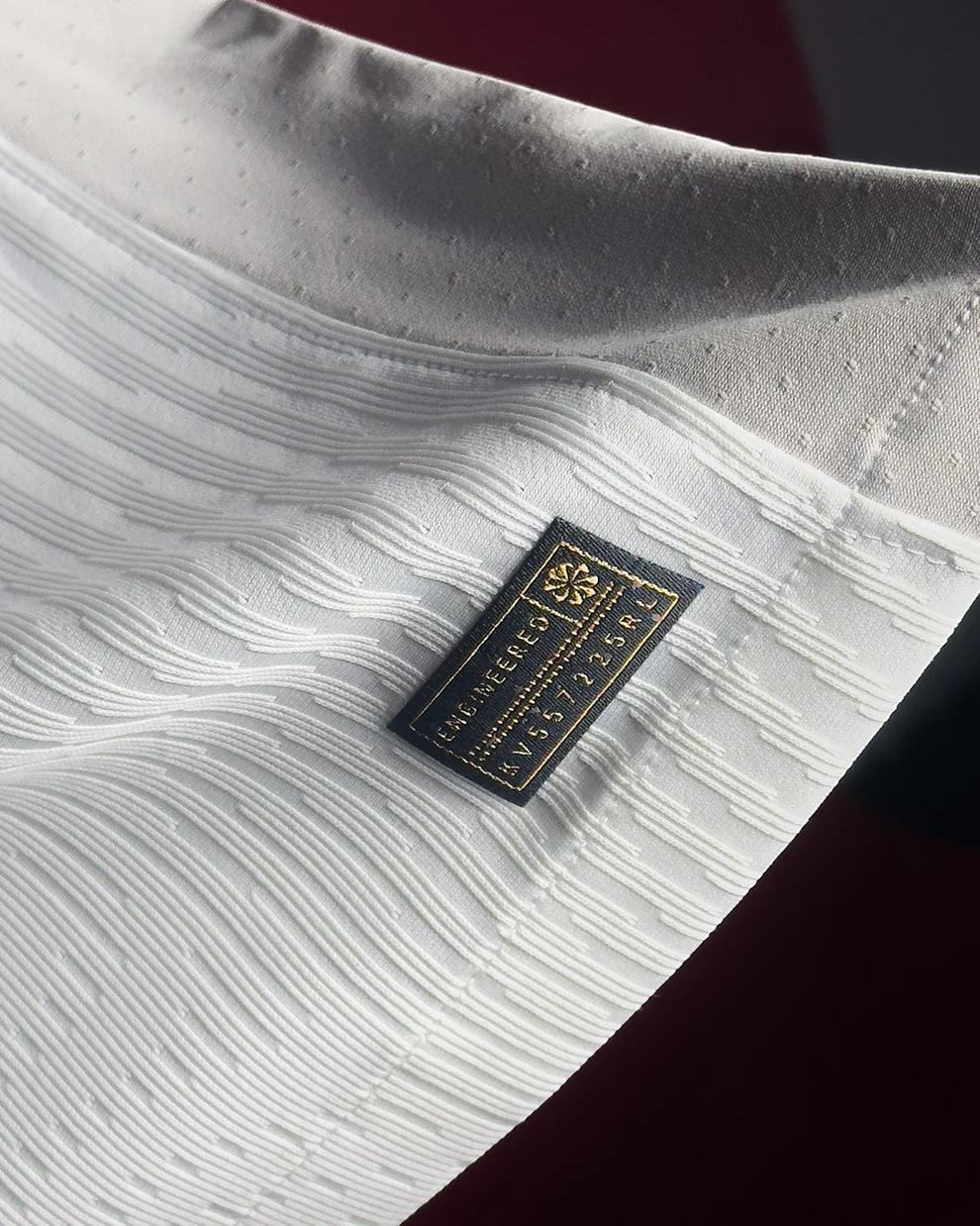 Hoop Store close up of Tottenham Hotspur 2025 home jersey white fabric texture and woven label