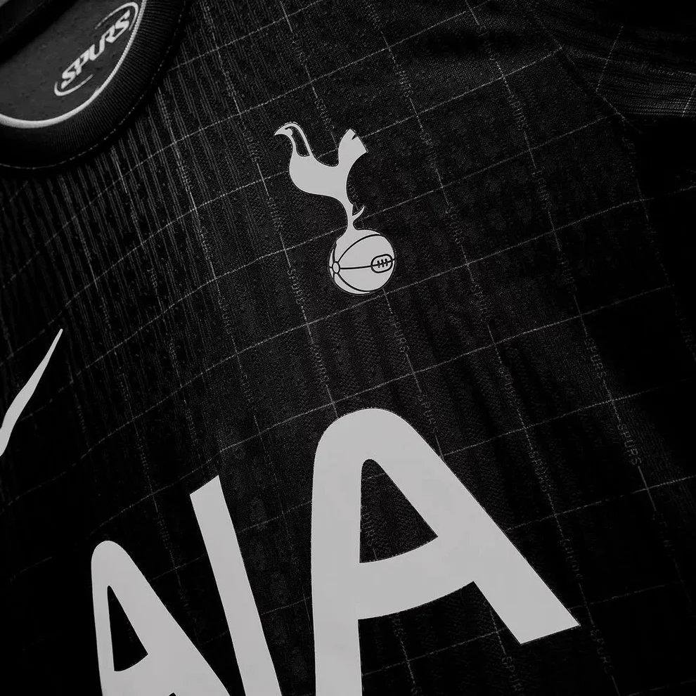 Hoop Store black Tottenham Hotspur away jersey 2025-26 close up showing crest AIA sponsor and Nike swoosh