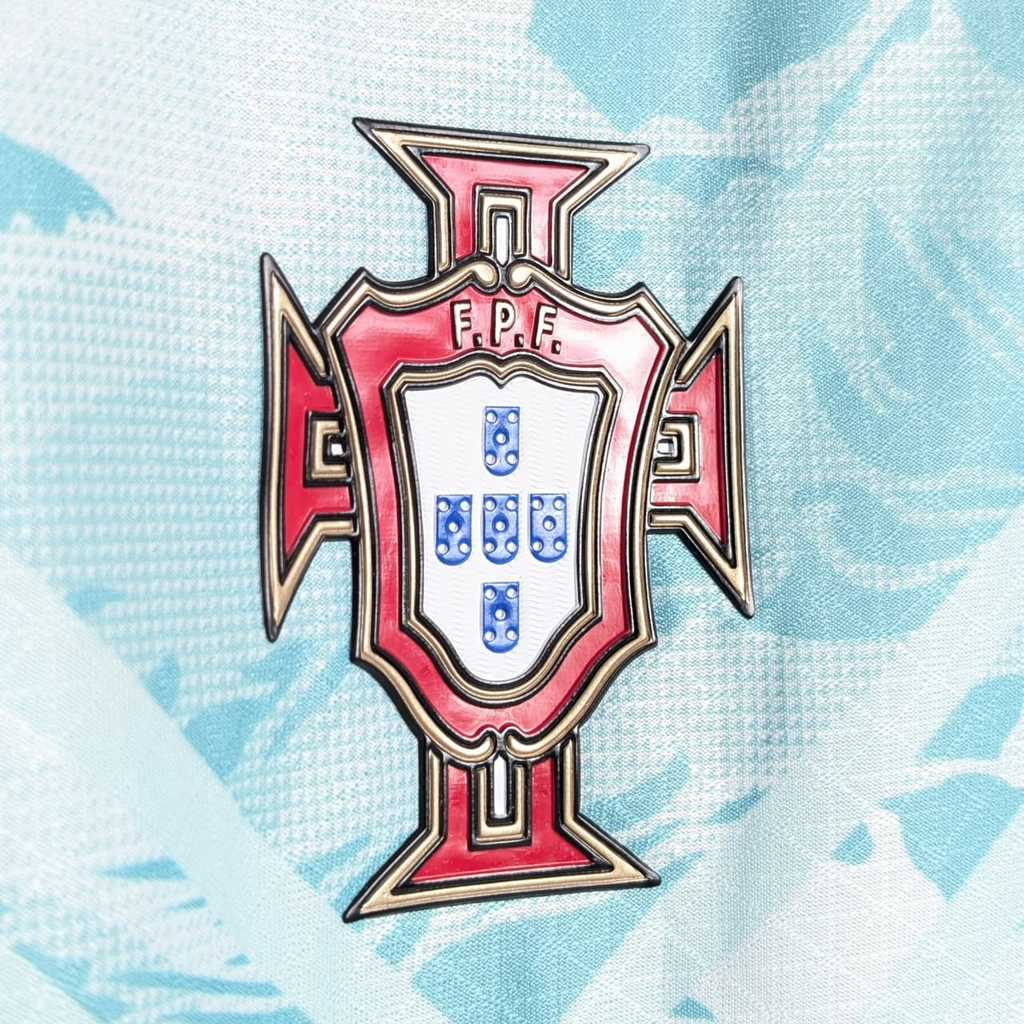 Close-up of the Portugal World Cup 2026 away jersey badge featuring the national emblem and vibrant design