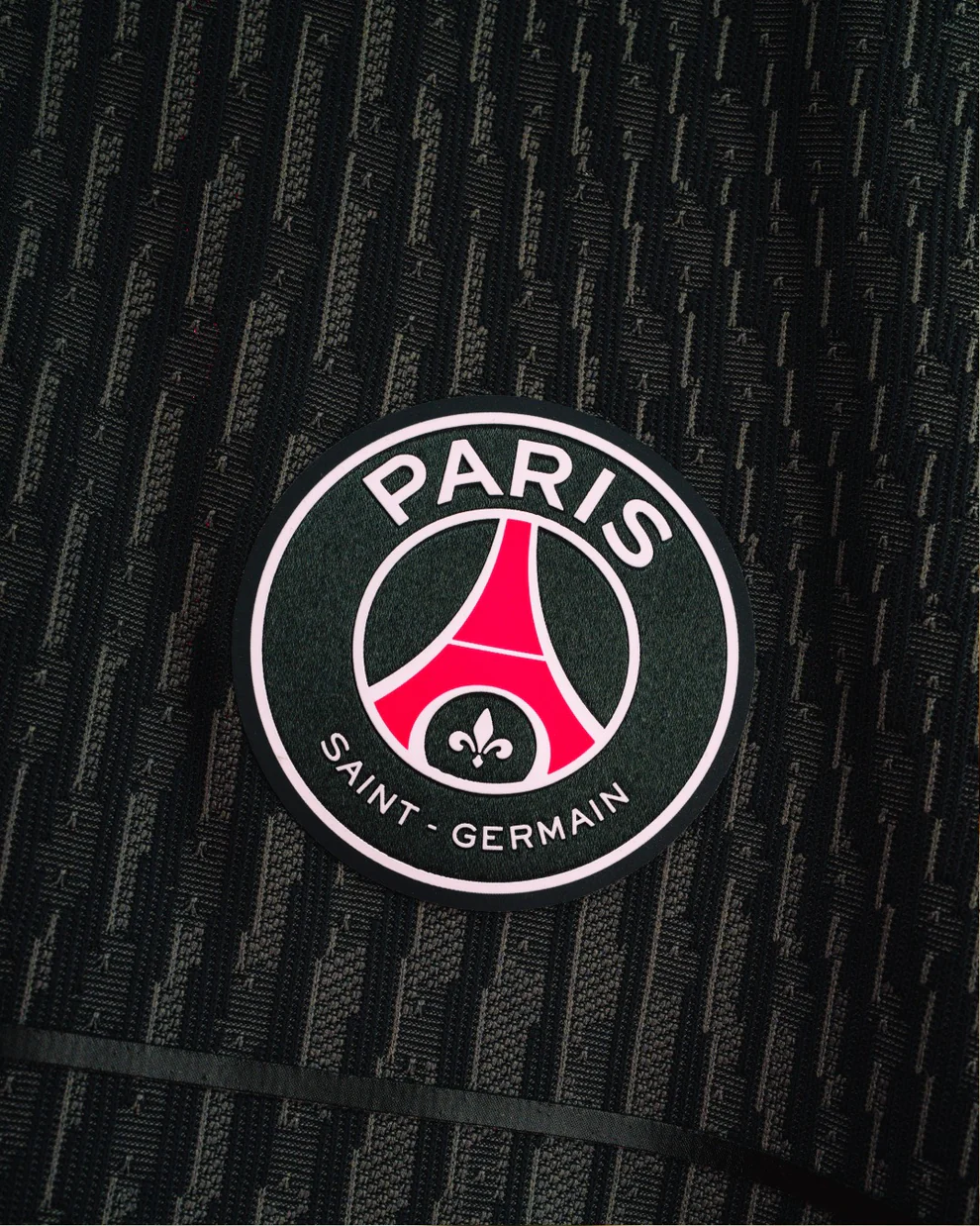 Close-up of the PSG fourth jersey 2025-26 player version logo with Paris Saint-Germain branding.
