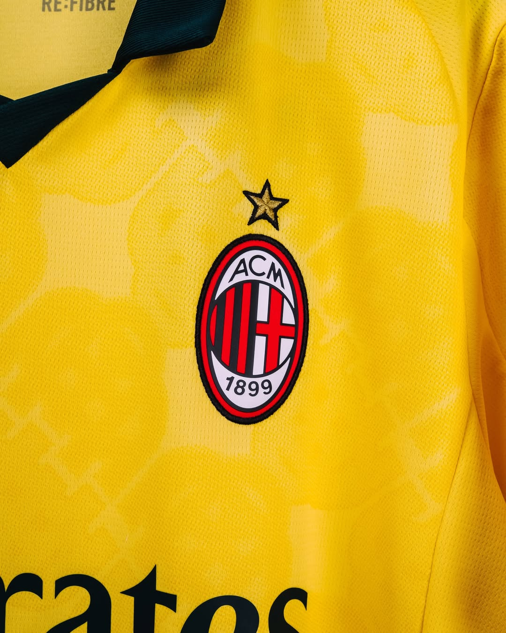 Hoop Store yellow AC Milan 2025-26 third jersey pre order close up of club crest and black V collar
