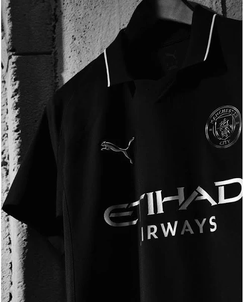 Hoop Store Manchester City away jersey 2025 in black with white logo and Etihad Airways sponsor